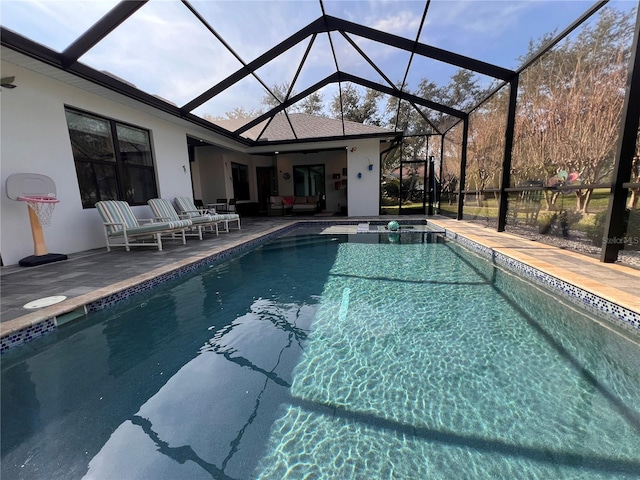 view of swimming pool with outdoor lounge area, a patio, and a lanai