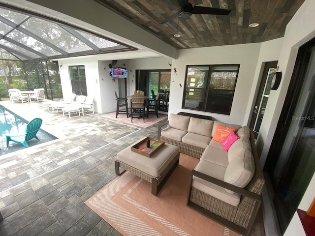 view of patio / terrace featuring an outdoor living space, a lanai, and ceiling fan