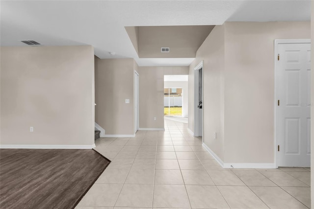 hall with light tile patterned floors