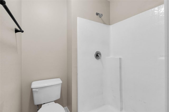 bathroom featuring toilet and walk in shower