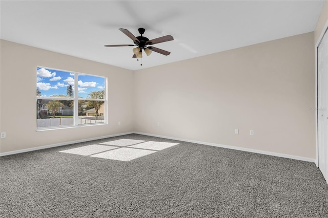 carpeted empty room featuring ceiling fan