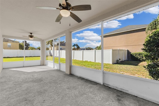 unfurnished sunroom with ceiling fan