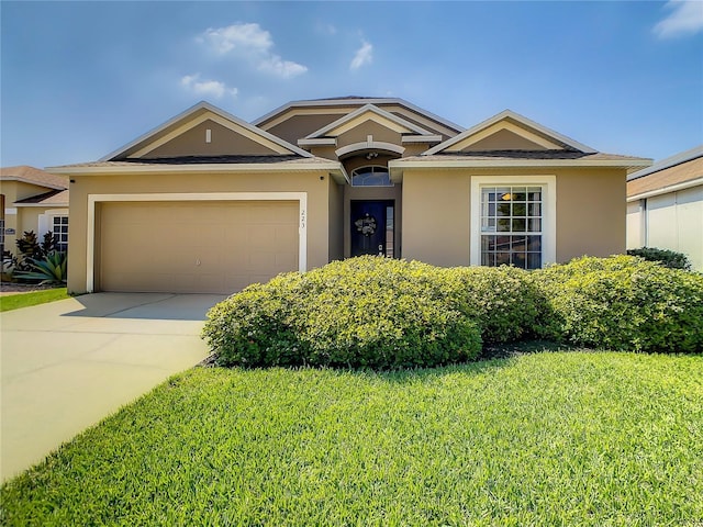 view of front of house featuring a front yard and a garage