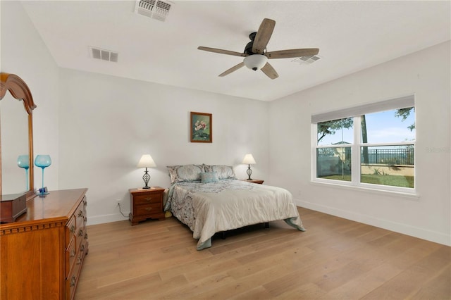 bedroom with light hardwood / wood-style floors and ceiling fan