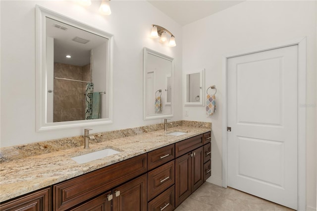 bathroom featuring tile patterned floors, vanity, and walk in shower