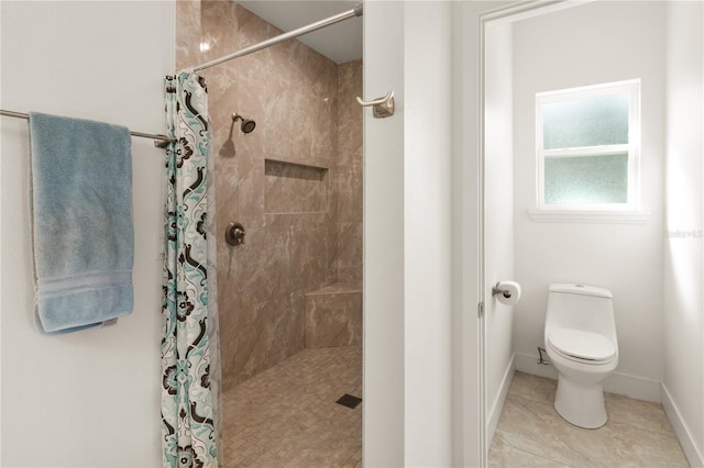 bathroom with a shower with shower curtain, toilet, and tile patterned floors