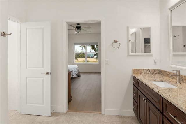 bathroom with tile patterned floors, ceiling fan, and vanity