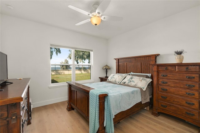 bedroom with ceiling fan and light hardwood / wood-style flooring