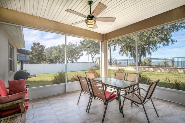 sunroom featuring ceiling fan