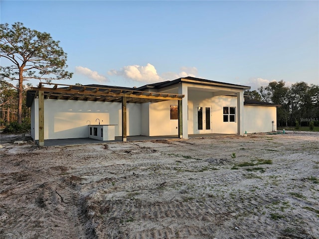 exterior space featuring french doors and stucco siding