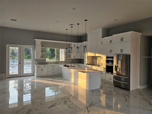 kitchen with visible vents, a center island with sink, appliances with stainless steel finishes, marble finish floor, and white cabinetry