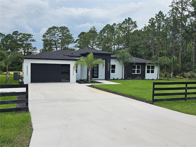 42157 Tamarac St, Eustis, FL 32736 - view of front facade featuring a garage, cooling unit, concrete driveway, and stucco siding