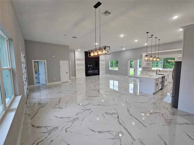 42157 Tamarac St, Eustis, FL 32736 - kitchen featuring appliances with stainless steel finishes, a sink, open floor plan, light marble finish flooring, and recessed lighting