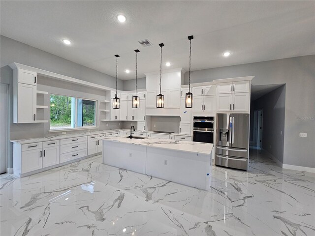 42157 Tamarac St, Eustis, FL 32736 - kitchen featuring open shelves, appliances with stainless steel finishes, a sink, a center island with sink, and white cabinets