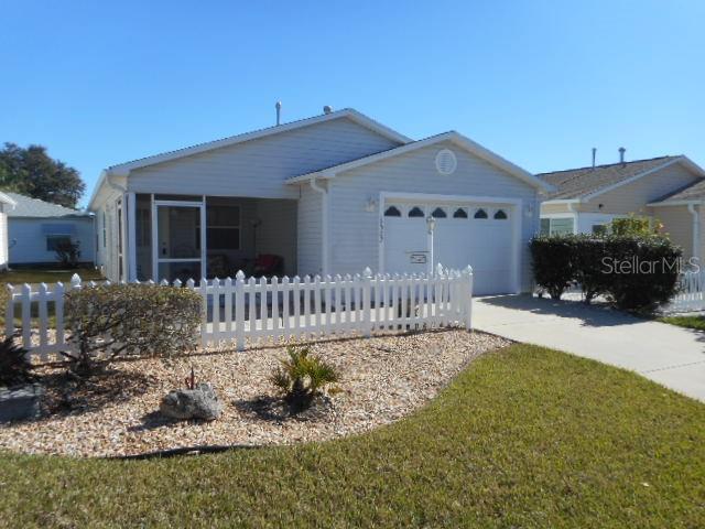 ranch-style home featuring a garage and a front yard