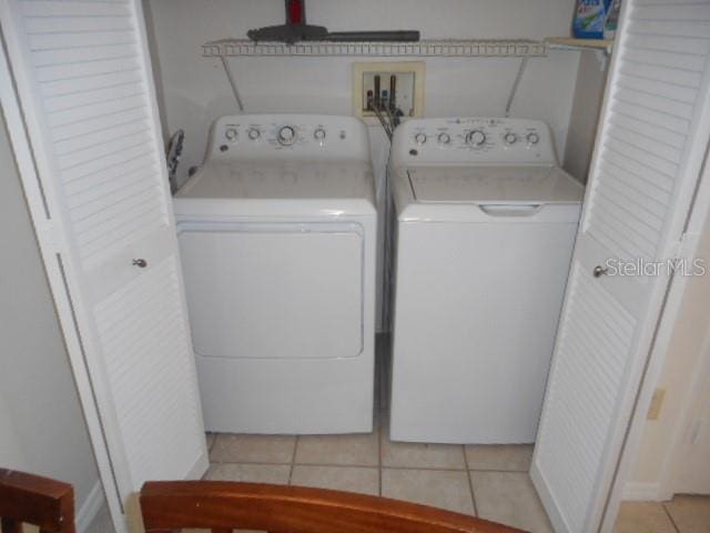 washroom featuring light tile patterned floors and washer and dryer