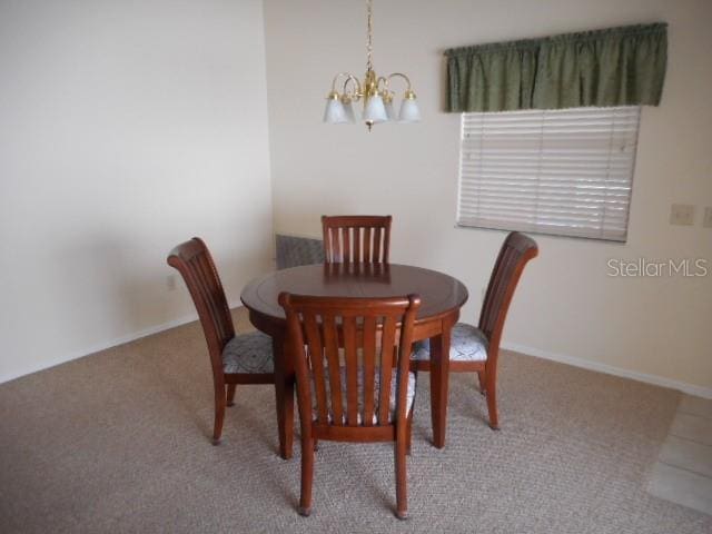 dining space with a notable chandelier and carpet