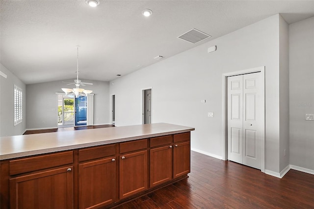 kitchen with dark hardwood / wood-style floors, hanging light fixtures, and vaulted ceiling