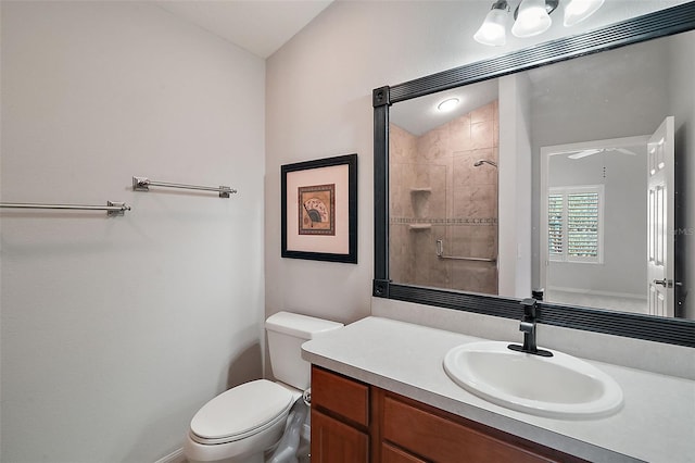 bathroom with vanity, toilet, and a shower