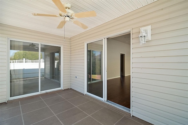 unfurnished sunroom with ceiling fan