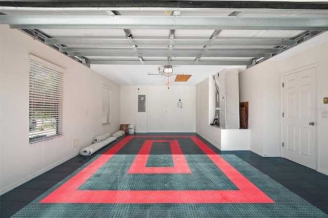 garage with electric panel and a garage door opener