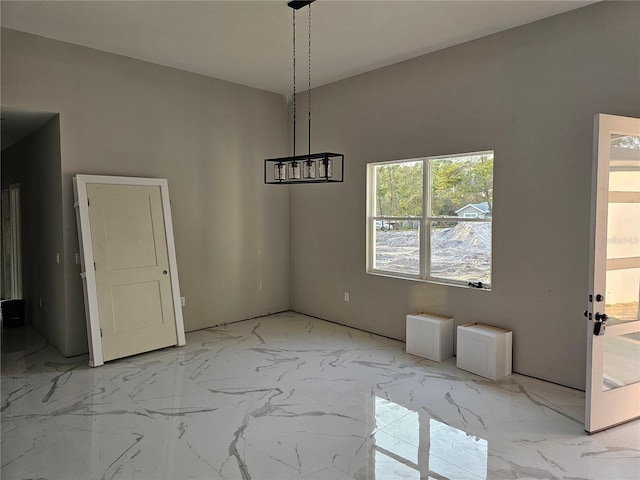 unfurnished dining area featuring marble finish floor