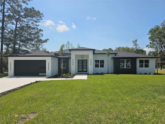 42200 Chinaberry St, Eustis, FL 32736 - prairie-style home with french doors, stucco siding, an attached garage, driveway, and a front yard