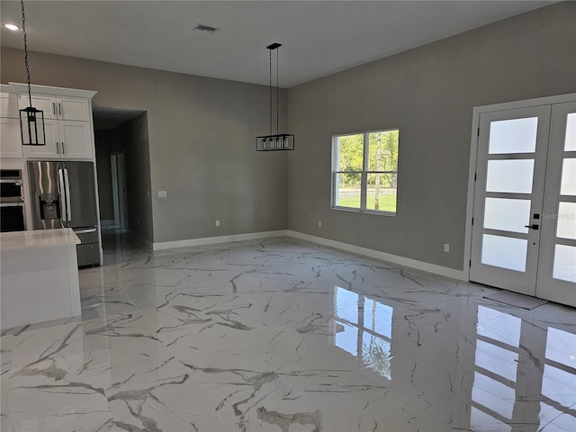 42200 Chinaberry St, Eustis, FL 32736 - unfurnished dining area with light marble finish floors, baseboards, and french doors