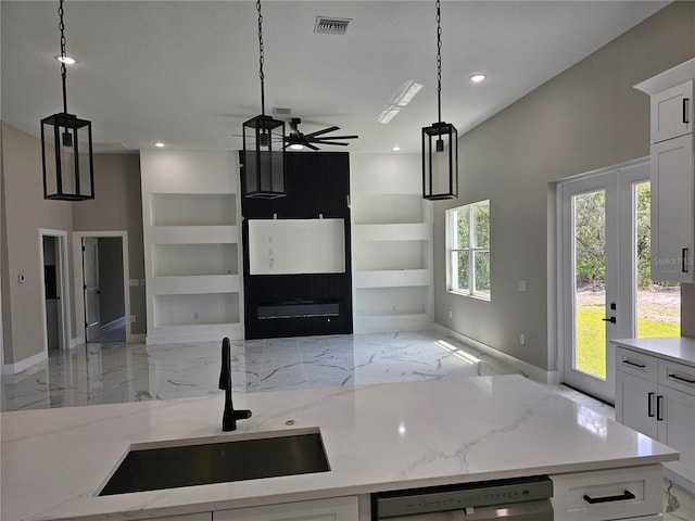 42200 Chinaberry St, Eustis, FL 32736 - kitchen with open floor plan, a sink, a ceiling fan, built in features, and light marble finish flooring