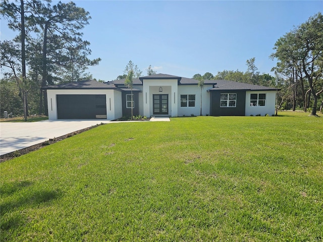 42200 Chinaberry St, Eustis, FL 32736 - view of front facade with stucco siding, french doors, driveway, an attached garage, and a front lawn