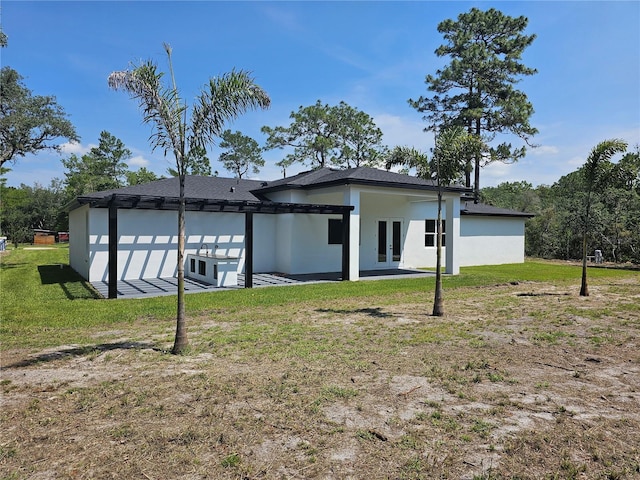 42200 Chinaberry St, Eustis, FL 32736 - back of house with french doors, a yard, stucco siding, and a patio