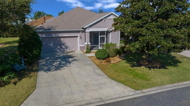 view of front of property featuring a garage, driveway, a front lawn, and stucco siding