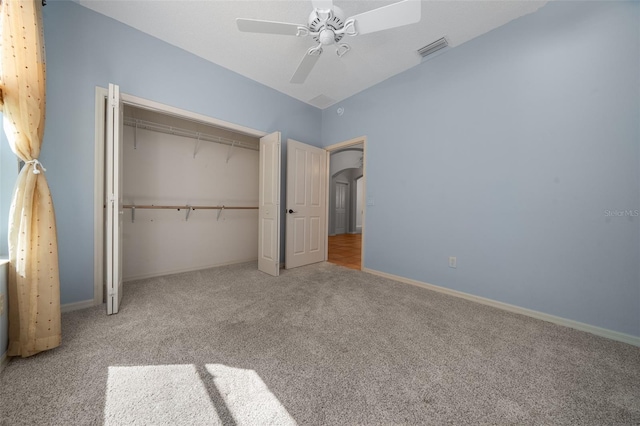 unfurnished bedroom featuring a ceiling fan, visible vents, baseboards, a closet, and carpet