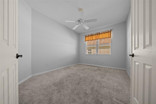 carpeted spare room with a textured ceiling, ceiling fan, lofted ceiling, and baseboards