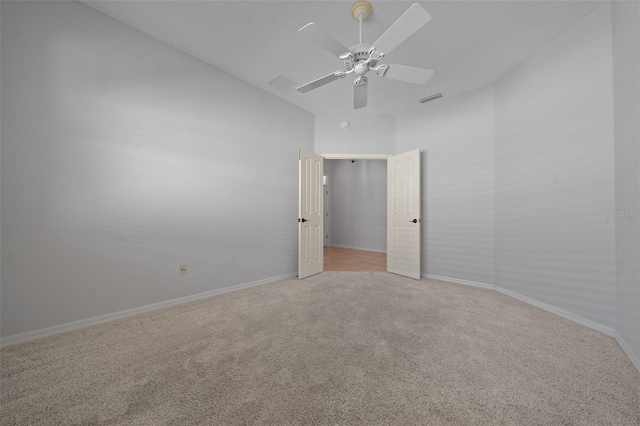 unfurnished room featuring baseboards, ceiling fan, visible vents, and light colored carpet