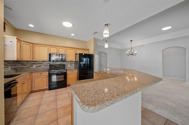 kitchen featuring tasteful backsplash, arched walkways, light colored carpet, black appliances, and light brown cabinets