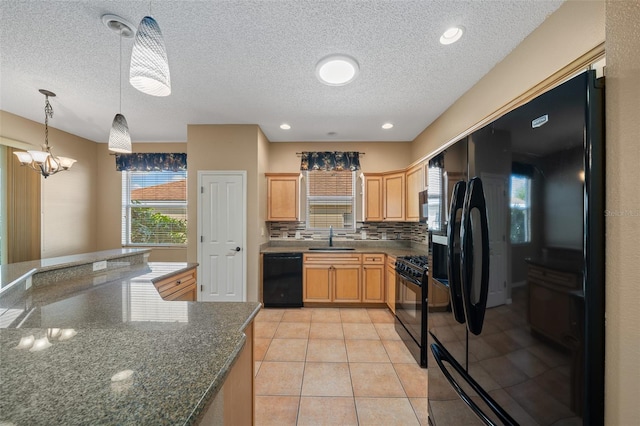 kitchen featuring decorative backsplash, hanging light fixtures, black appliances, a sink, and light tile patterned flooring