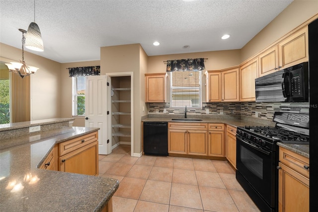 kitchen featuring decorative light fixtures, tasteful backsplash, light tile patterned flooring, a sink, and black appliances