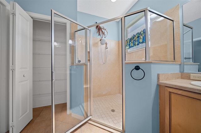 bathroom featuring a stall shower, tile patterned flooring, and vanity