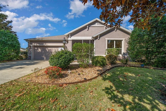 view of front facade featuring driveway, a garage, a front lawn, and stucco siding