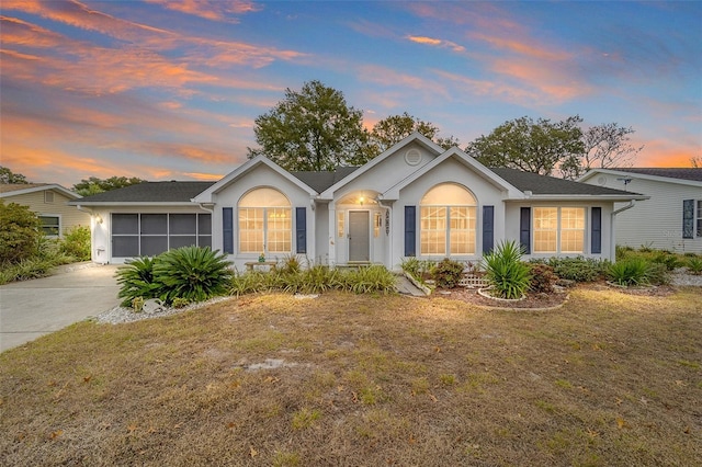 ranch-style house featuring a lawn