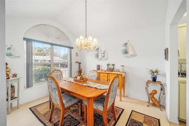 carpeted dining space featuring vaulted ceiling and an inviting chandelier