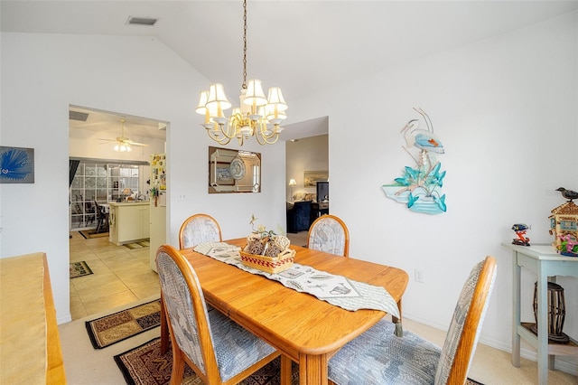 tiled dining space with ceiling fan with notable chandelier and vaulted ceiling