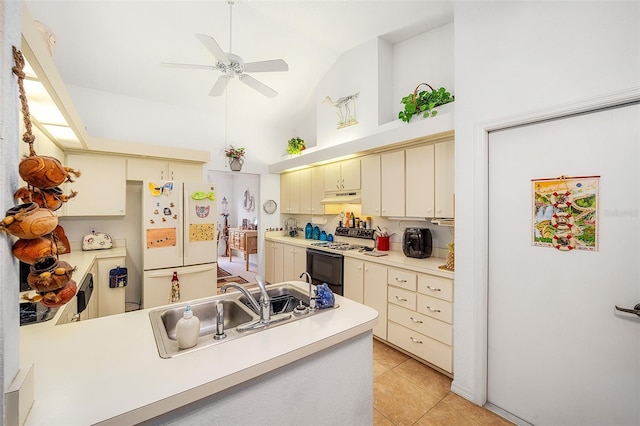 kitchen with white appliances, ceiling fan, light tile patterned floors, cream cabinetry, and lofted ceiling