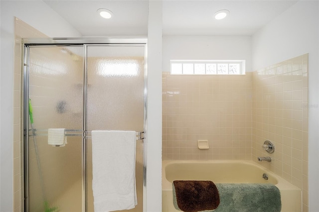 bathroom featuring separate shower and tub