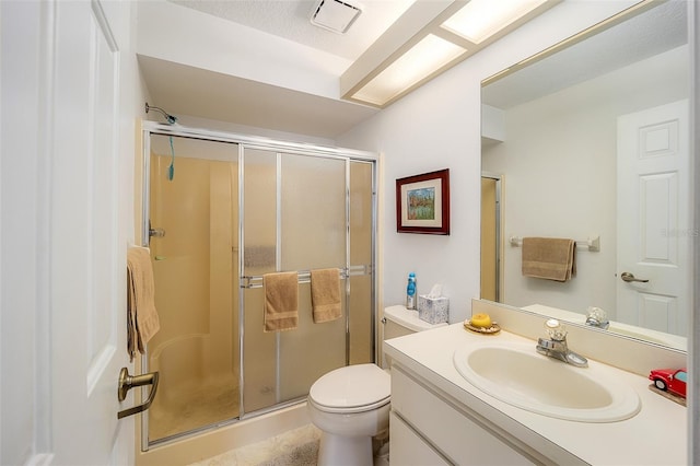 bathroom with vanity, toilet, and walk in shower