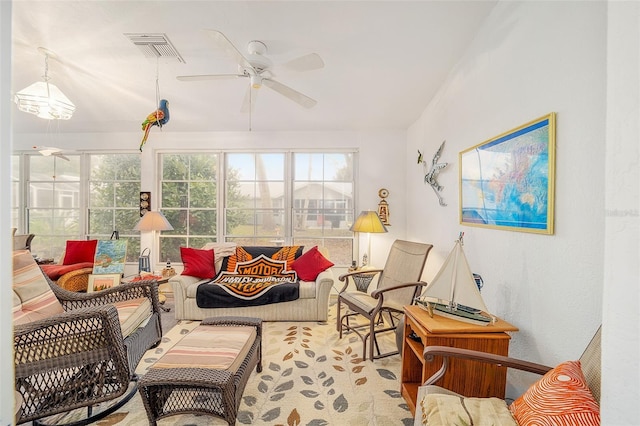 sunroom / solarium featuring ceiling fan