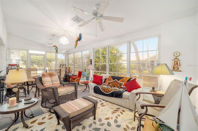 sunroom / solarium with vaulted ceiling, plenty of natural light, and ceiling fan