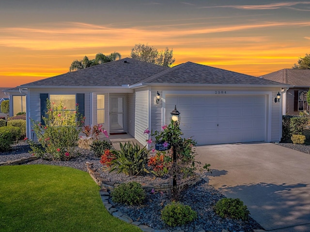 ranch-style house with a garage and a yard