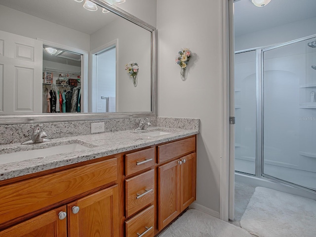 bathroom featuring vanity and an enclosed shower